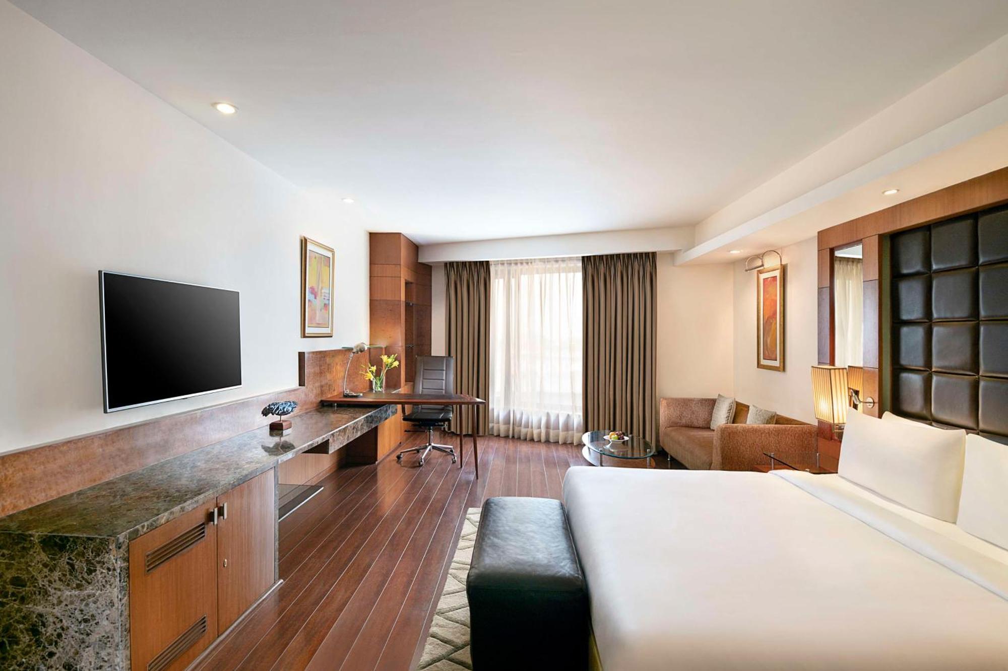 Deluxe Room with Happy Hours 01:00 PM to 06:00 PM, one way Airport Transfers and Free Pick up and drop to Worldmark Aerocity (subject to car availability)