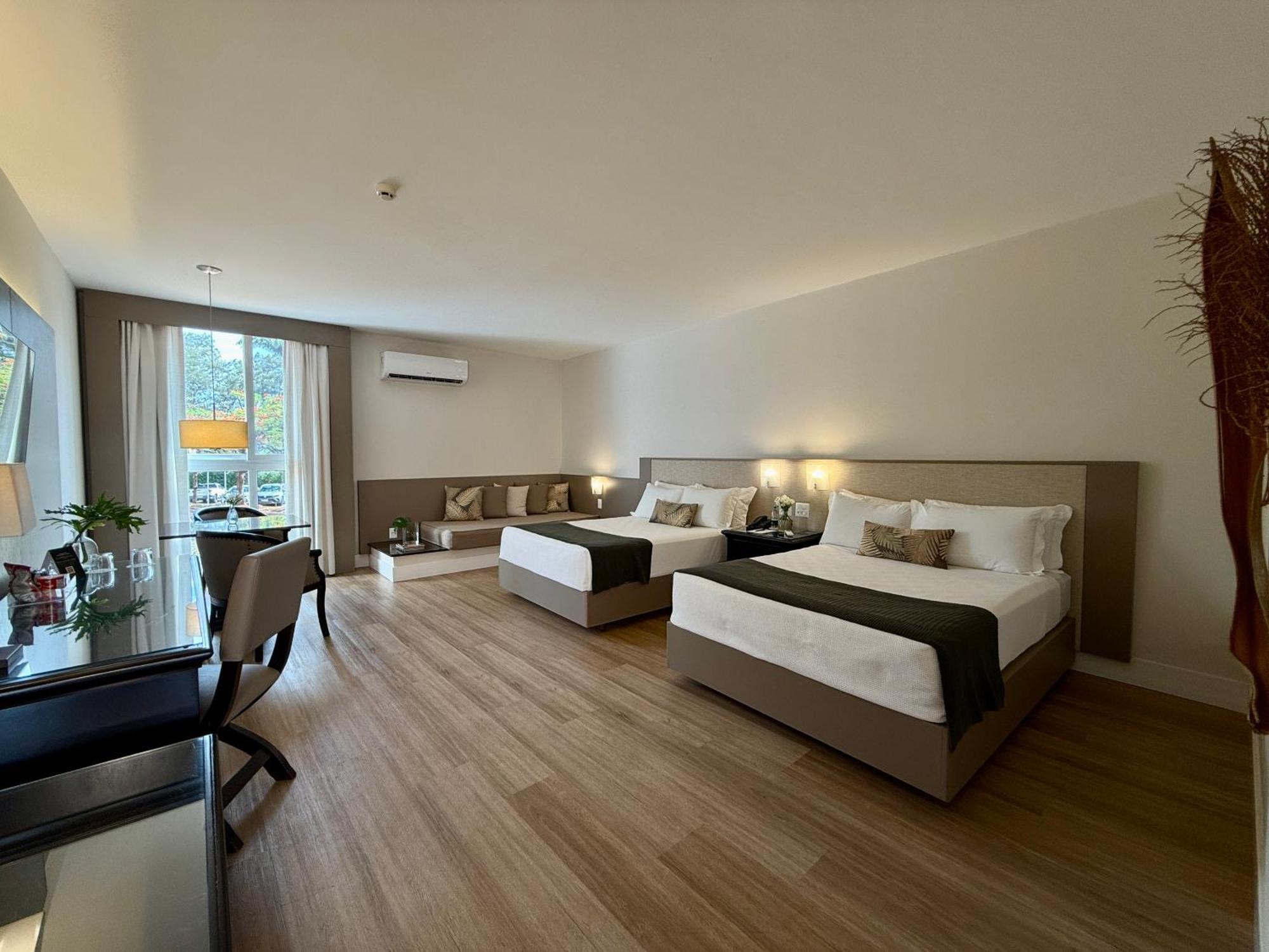 Deluxe room with 2 double beds and a garden view